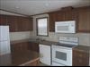 Kitchen.  St. Louis Maple cabinets.  They chose a smooth top electric range with white appliances.