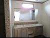 Furniture style lav-  Urban putty cabinets.  Transom window.  